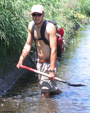 Steve digging in a stream exposure at Toberi marsh, Hokkaido