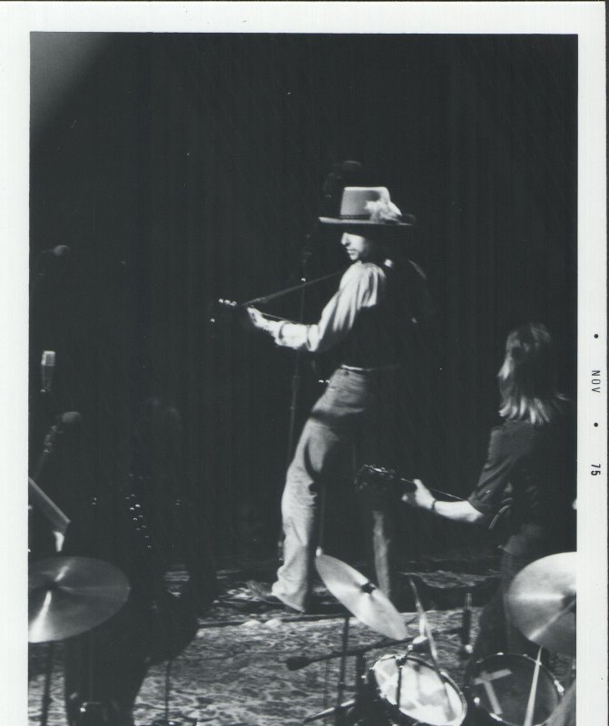 Bob Dylan performing live on stage.