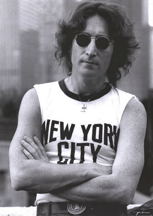 Infamous photo of John Lennon wearing a sleeveless shirt that says "New York City."
