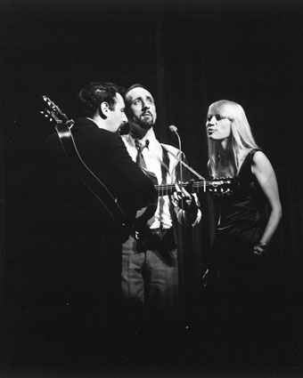 Peter, Paul and Mary performing live on stage.