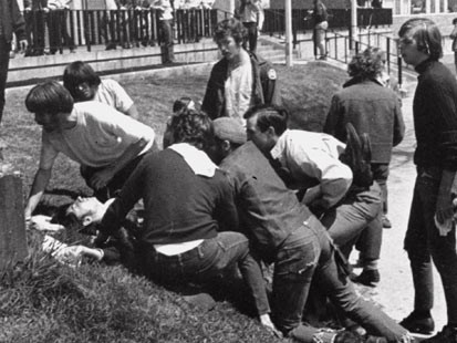 People assisting another fallen victim of the Kent State shootings involving the Ohio National Guard.