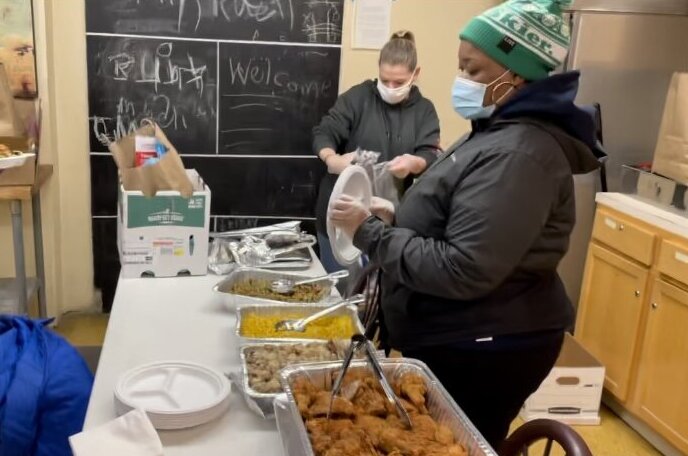 Volunteers preparing food for guests